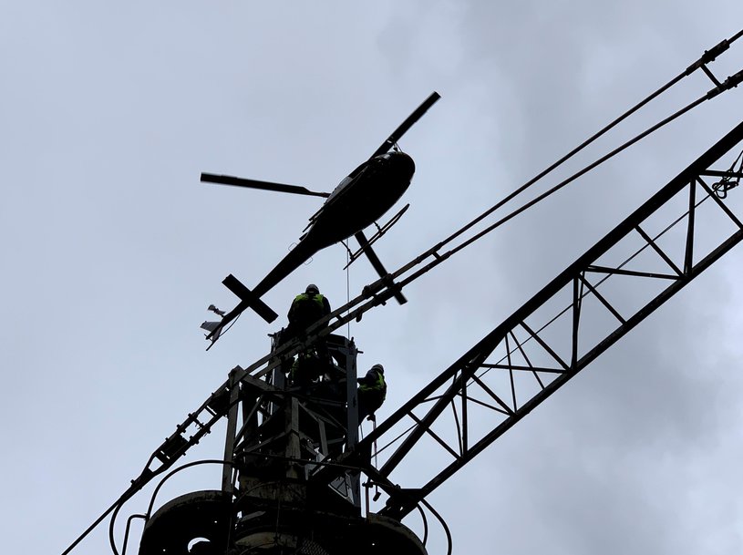 Potain MCT 58 installed by helicopter on hydroelectric dam at volcano foot